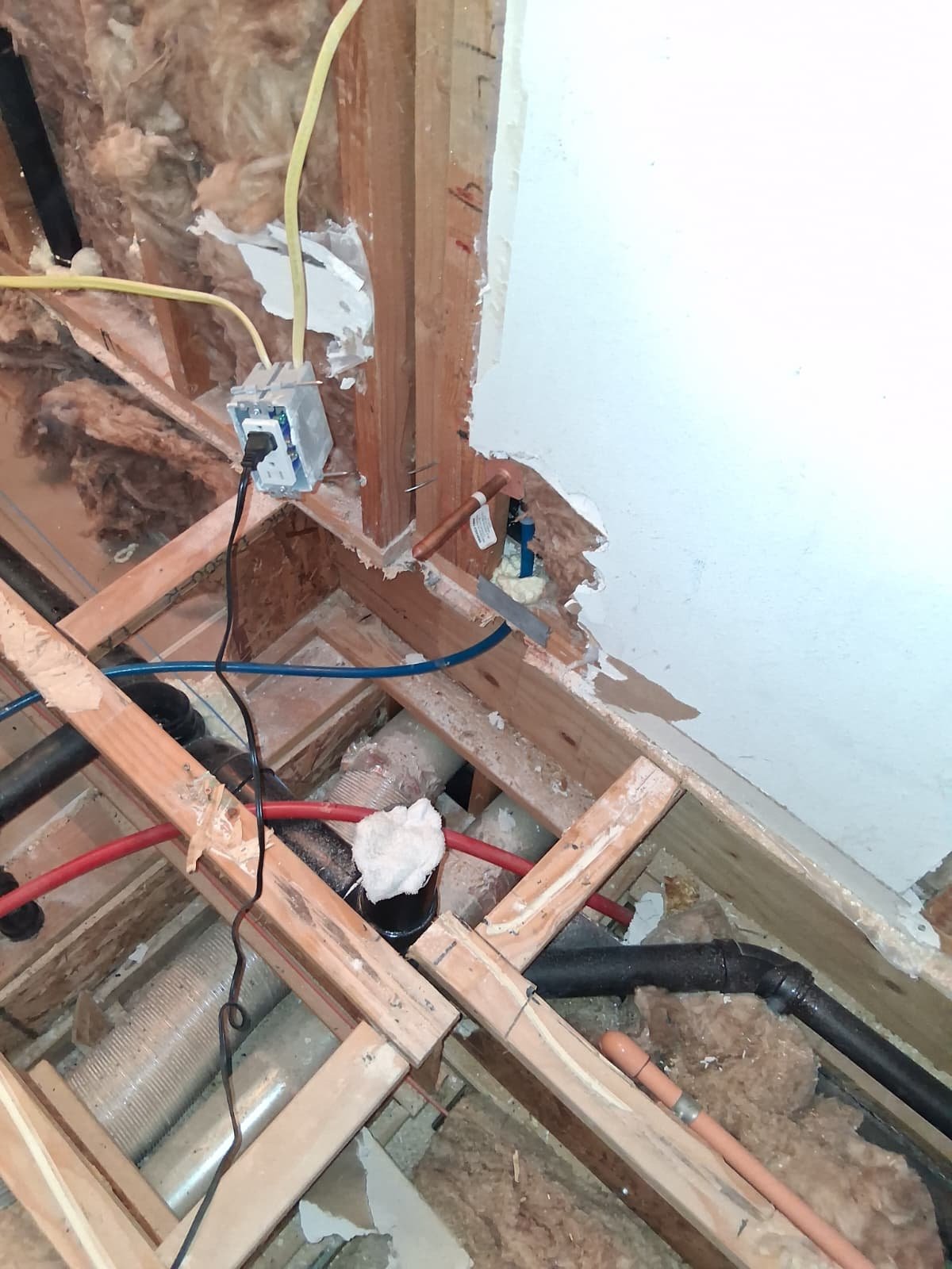 ABS drain and PEX supply lines rough-in in open floor framing