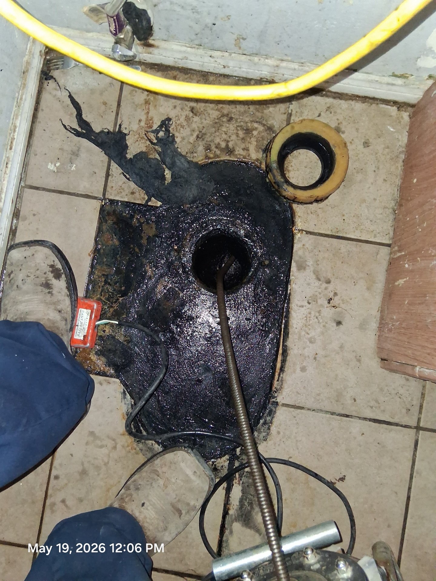 Toilet floor drain clearing with professional snake machine